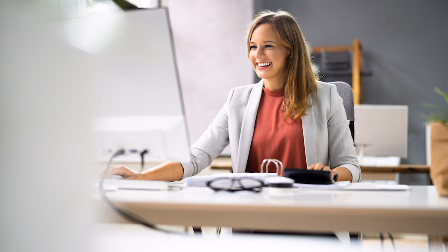 smiling bookkeeper in front of laptop