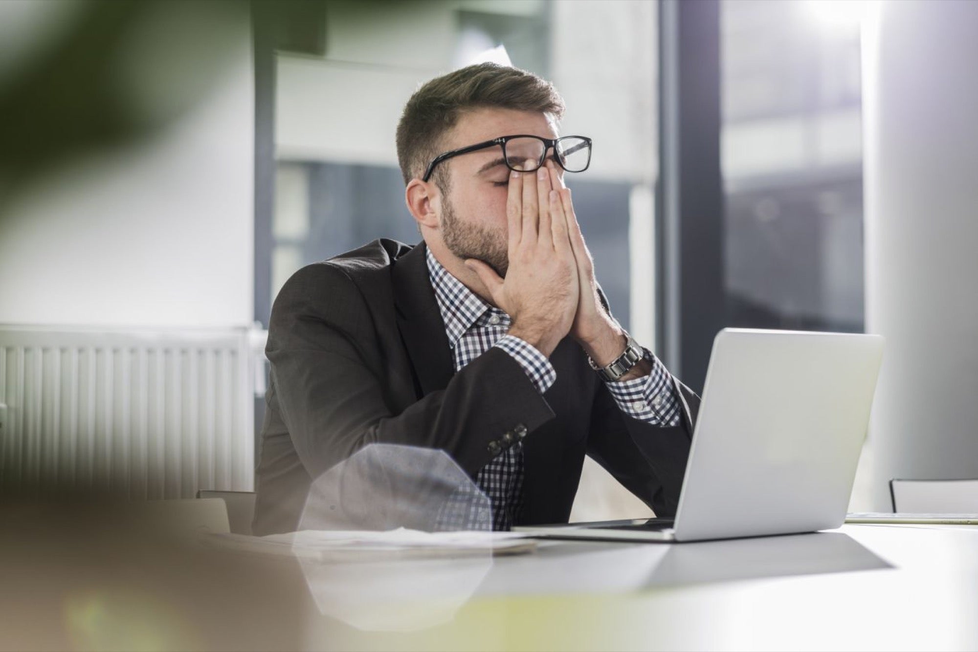 anxious man in front of laptop