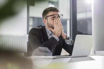 anxious man in front of laptop