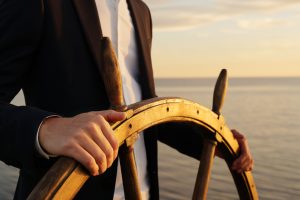 man holding a navigation wheel
