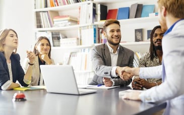 a businessman shaking hands with a client