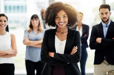 a smiling confident woman with her arms crossed