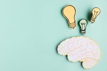 paper brain with light bulbs