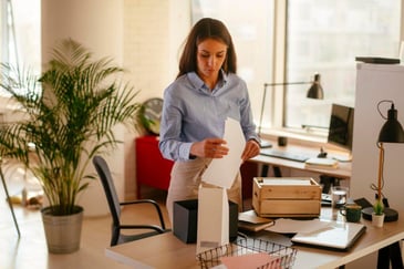 woman decluttering office table