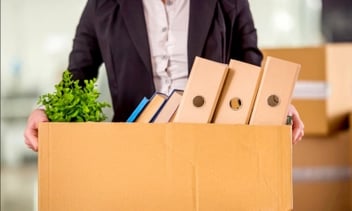 a man holding a box of this office stuff - fired
