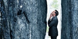 man facing a big rock