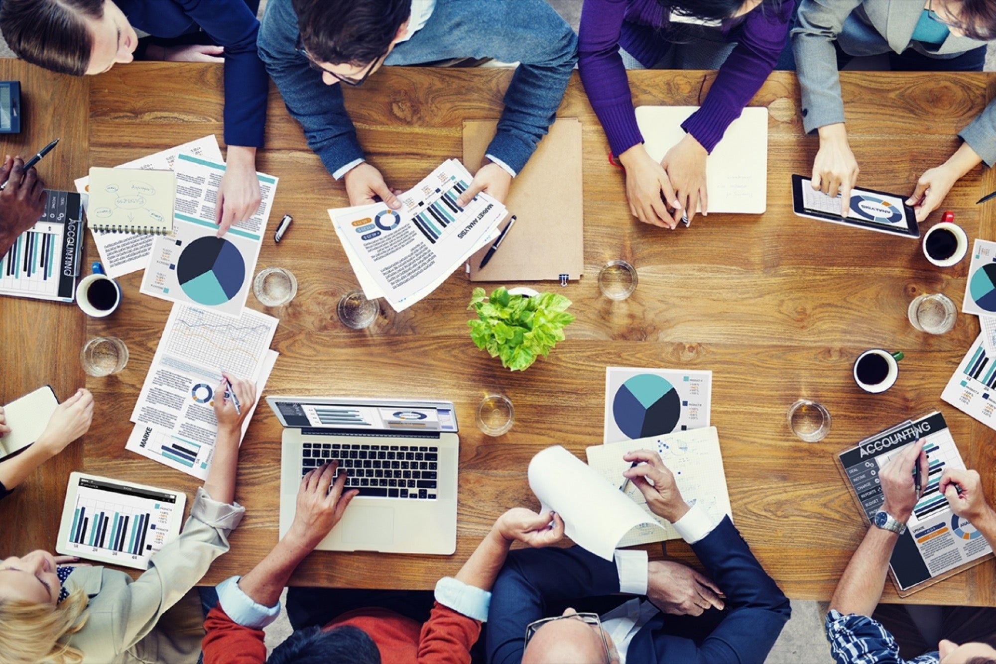 group of people with graphs and reports