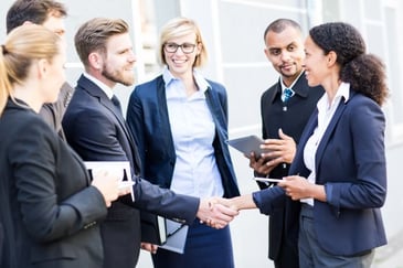 a group of sales professionals closing a deal