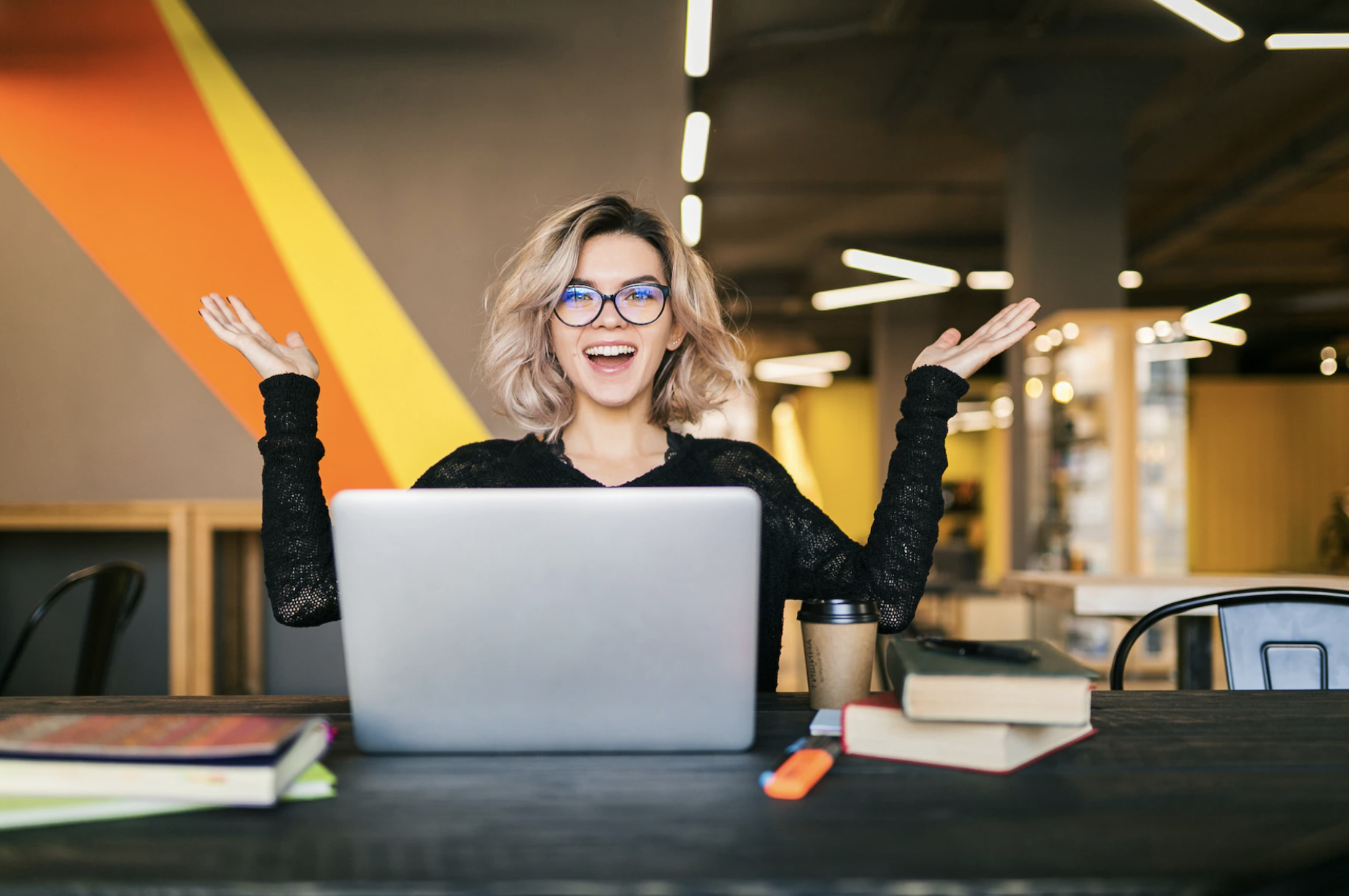 happy young woman in front of her laptop