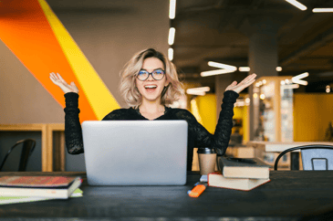 happy young woman in front of her laptop
