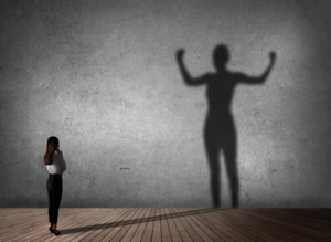 woman looking at her big shadow